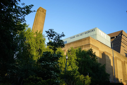 Photo of the Tate Modern during COVID-19 with letters in its windows spelling out "Thank you key workers"
